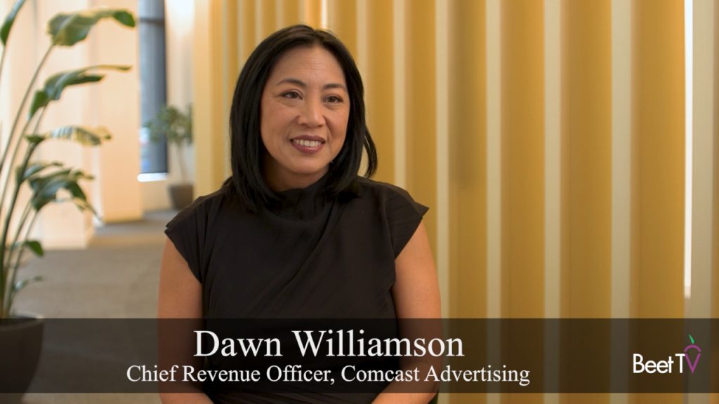 Dawn Williamson, Chief Revenue Officer at Comcast Advertising, speaking at an industry event, with a background suggesting a conference setting.