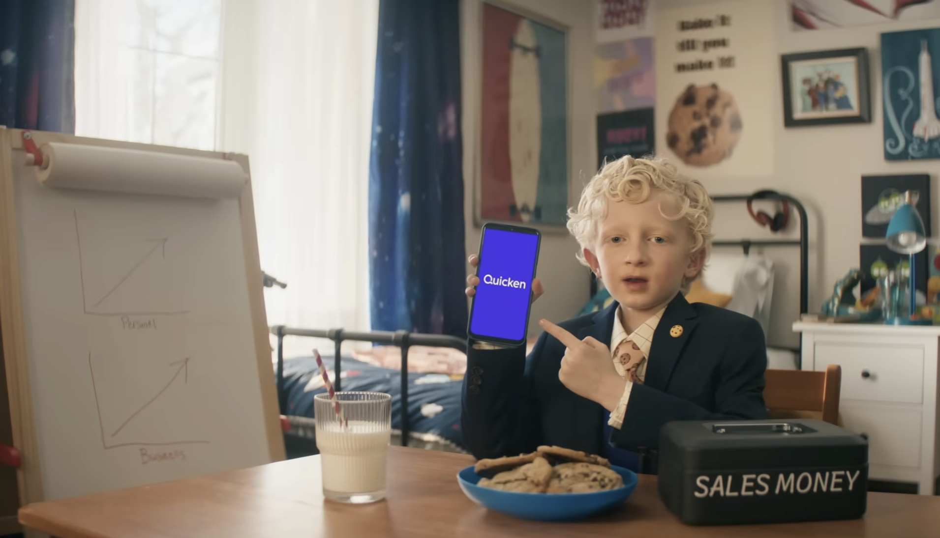 A young boy in a suit dramatically answers a toy phone, representing a small business owner in Quicken's campaign.