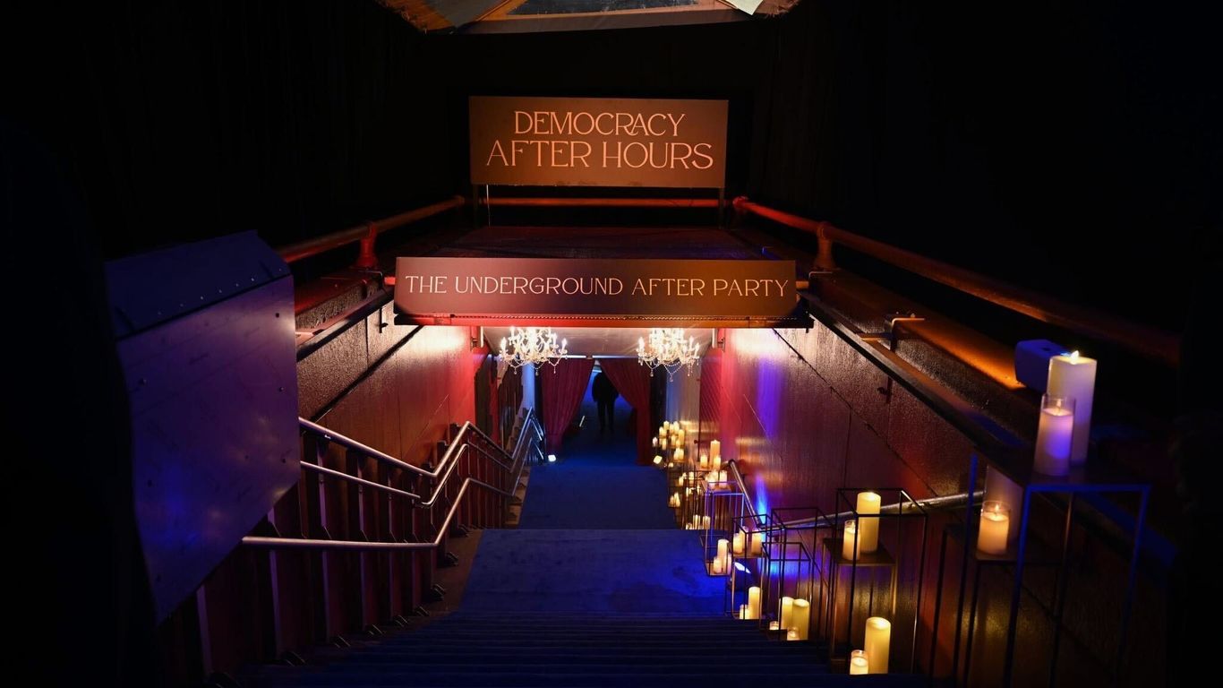 A crowd of people mingling at a sophisticated indoor event, suggesting a media or political gathering.