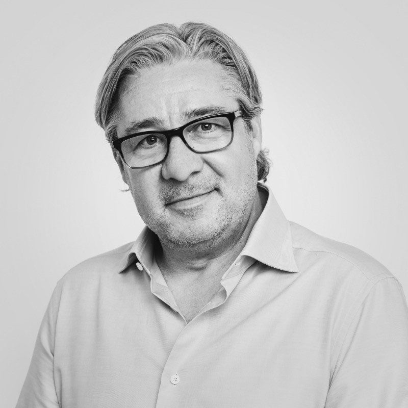 A digital graphic showing interconnected nodes representing AI agents and complex deal structures within a stylized television screen.