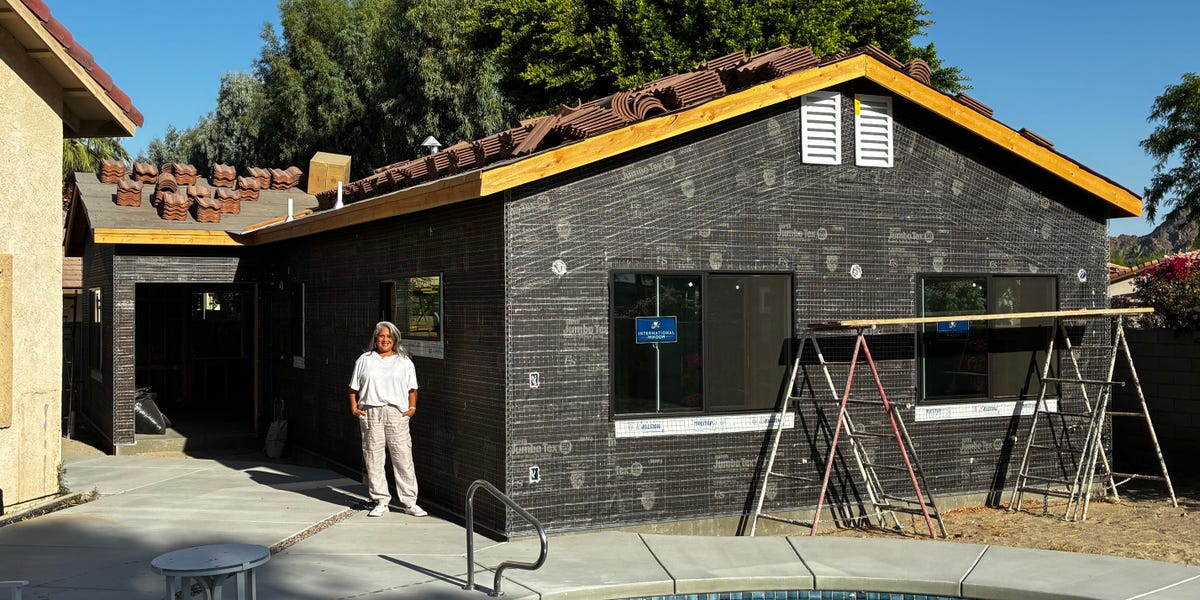 A rendering or photo of a modern, well-appointed accessory dwelling unit (ADU) in a backyard setting.