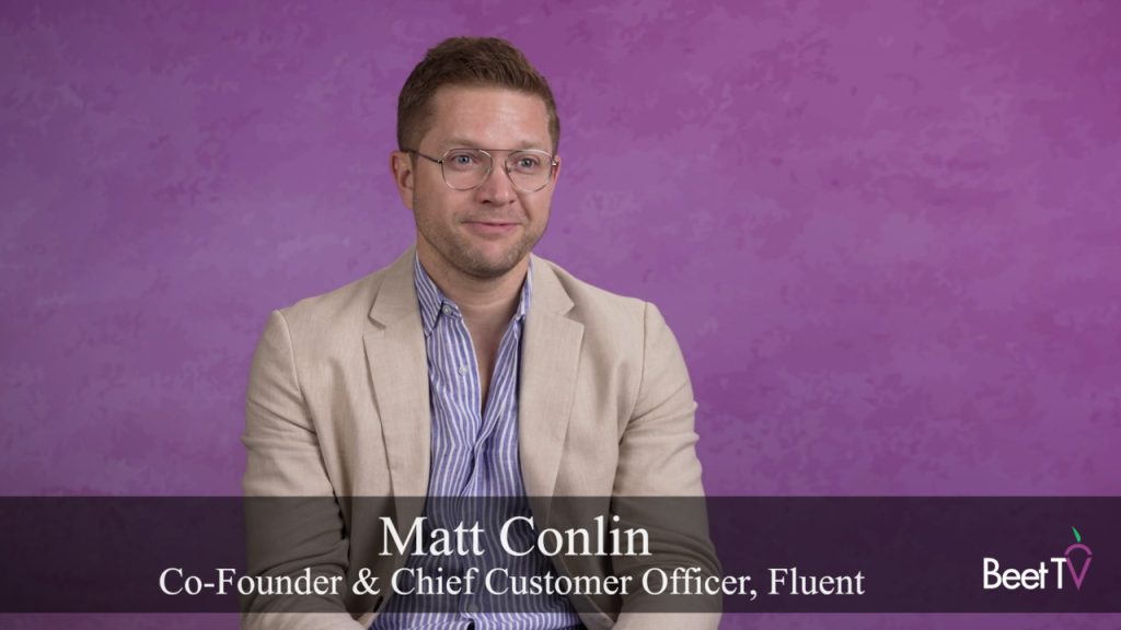 Matt Conlin speaking at a conference stage