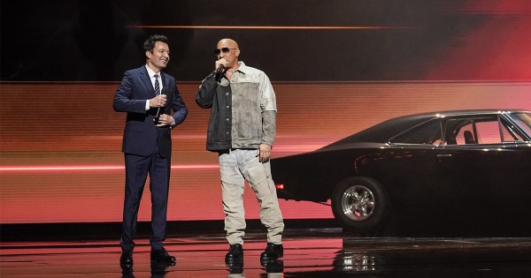 NBCUniversal upfront event stage with Vin Diesel and a presenter.
