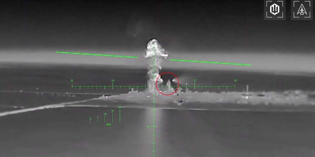 A long-range drone is shown with visible rocket pods attached under its wings, ready for launch.
